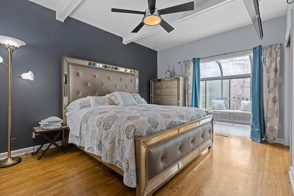 King bedroom with workspace, TV, and modern comforts
